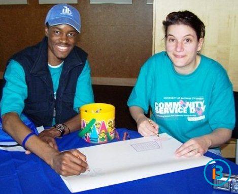During a post-community-service-reception, Ib and University of Baltimore colleague, Sophia, recap with a sketch, their activities during Community Service Day UB 2009.