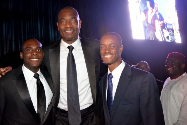 Ib & Dikembe Mutombo & Guest Former NBA player and humanitarian Dikembe Mutombo flanked by a guest and Ib at an awards dinner in Washington, DC.